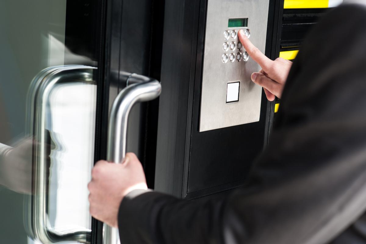 A person attempting to gain access to an area with an access control security door